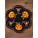 Top down view of the black wool candle mat with pumpkins and witch hats
