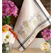 A vintage style dish towel with hand embroidered mason jars holding flowers and the words 
