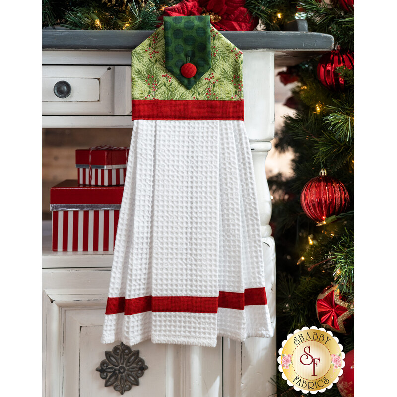 Red, green, and white towel displayed from a cabinet
