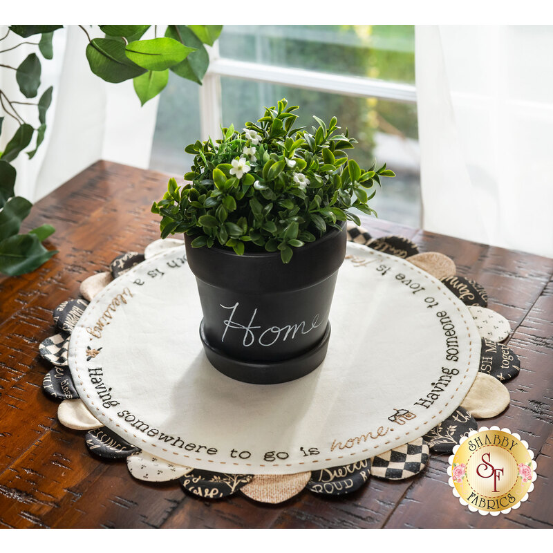 Welcome Home Scalloped Table Topper with a potted plant displayed on top