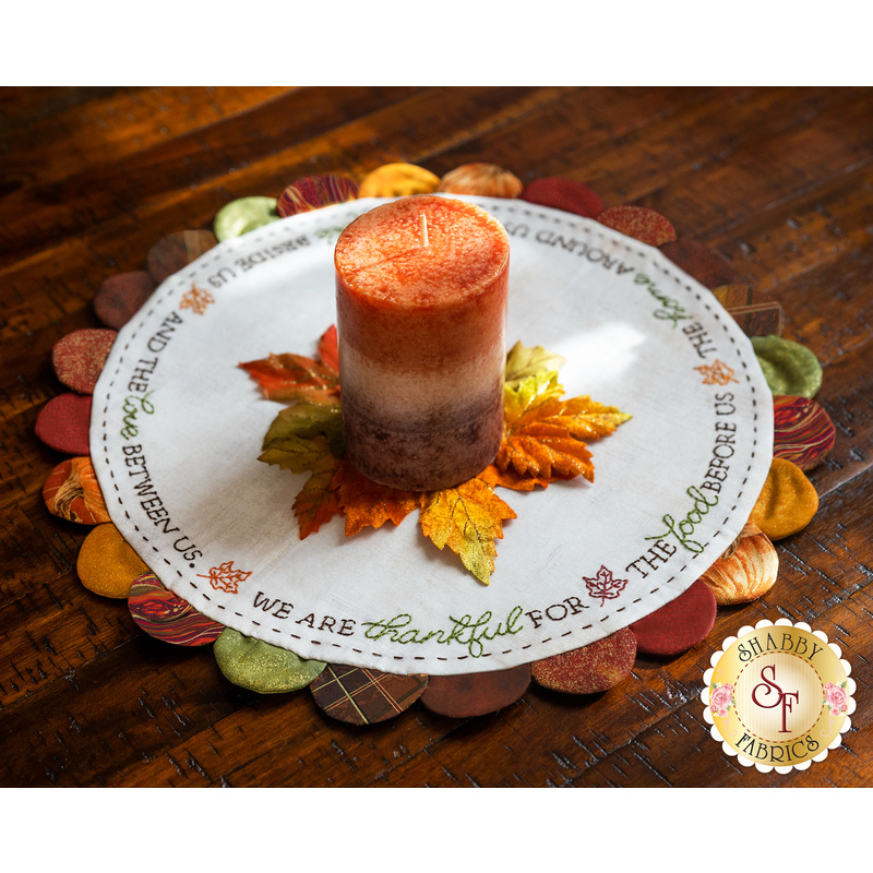 Round autumn themed Scalloped Table Topper with a candle displayed on top