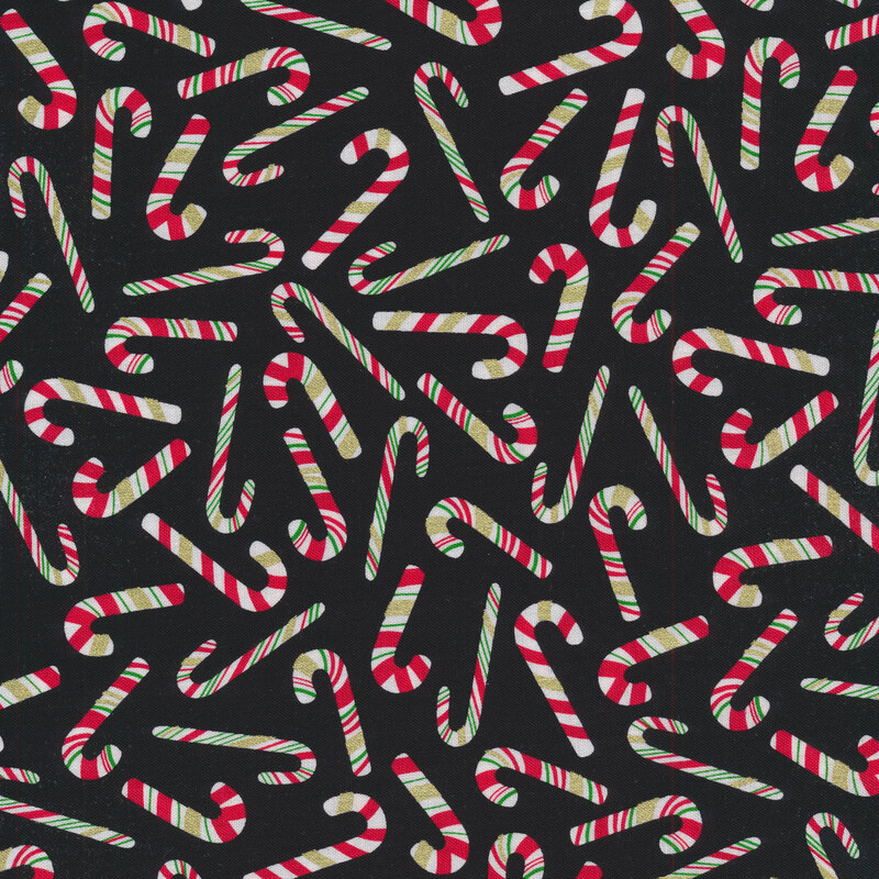 Tossed candy canes on a black background