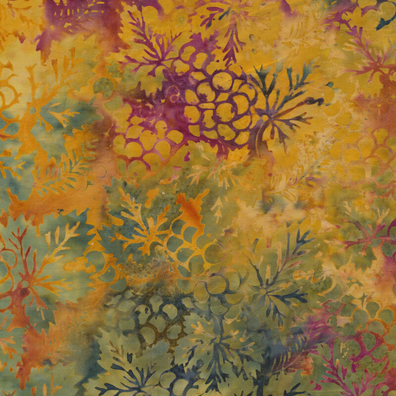 Multi colored batik fabric with bunches of grapes and autumn leaves on a mottled background