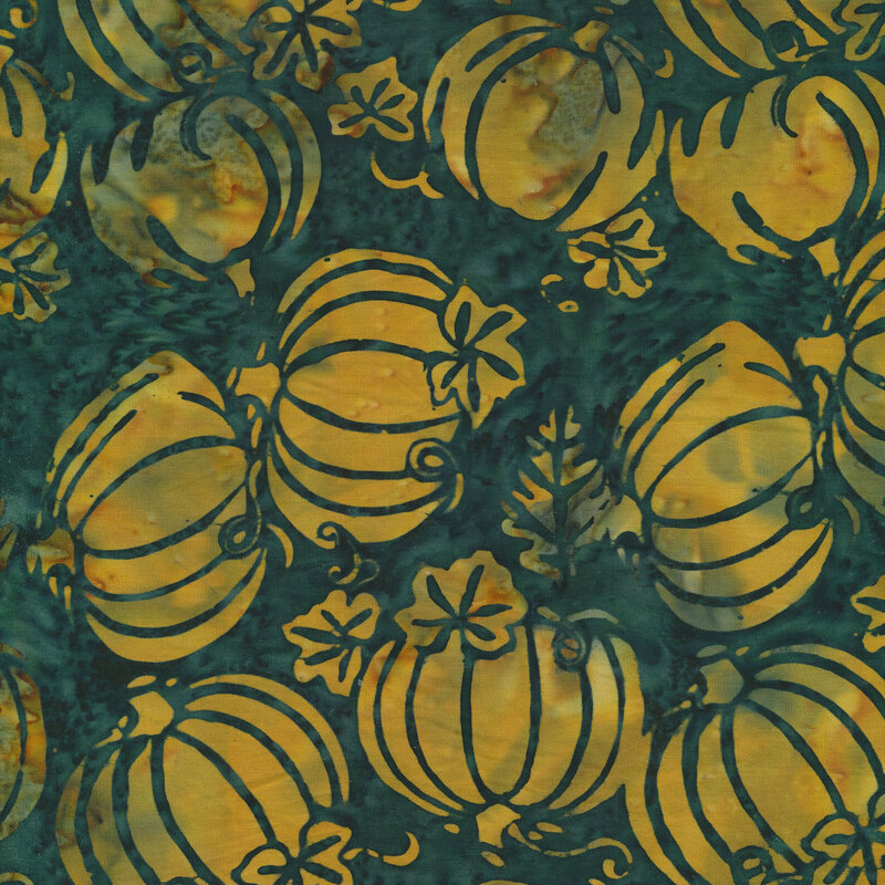 Mottled batik fabric with yellow pumpkins tossed on a green background