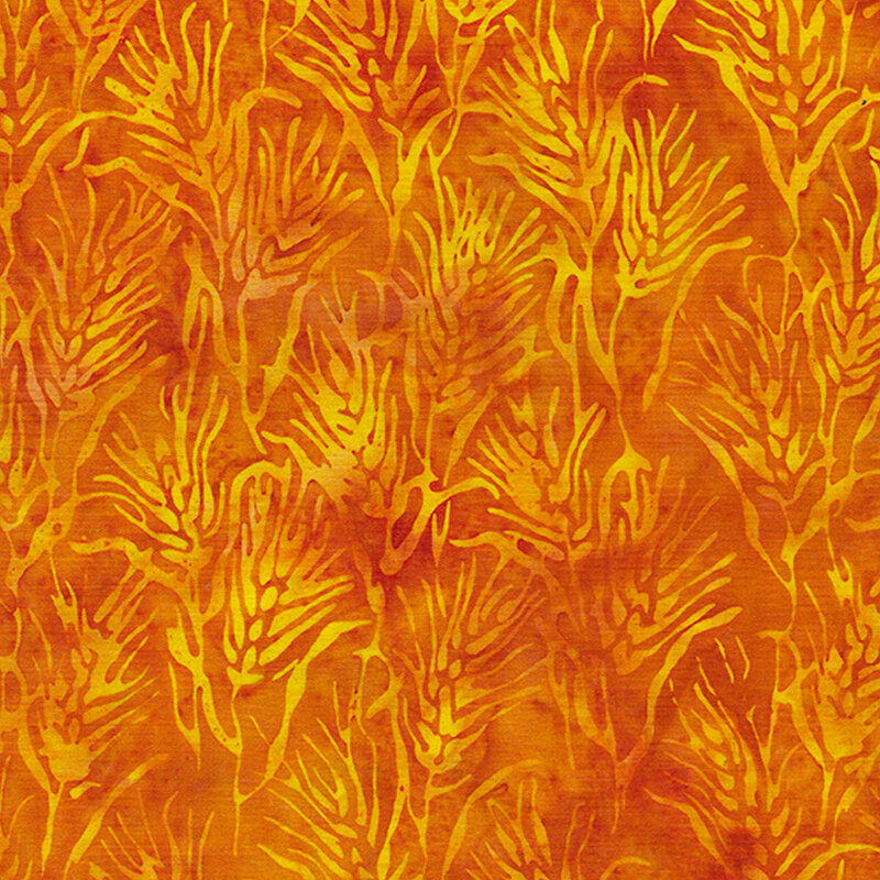 Heads of yellow wheat on a mottled orange background