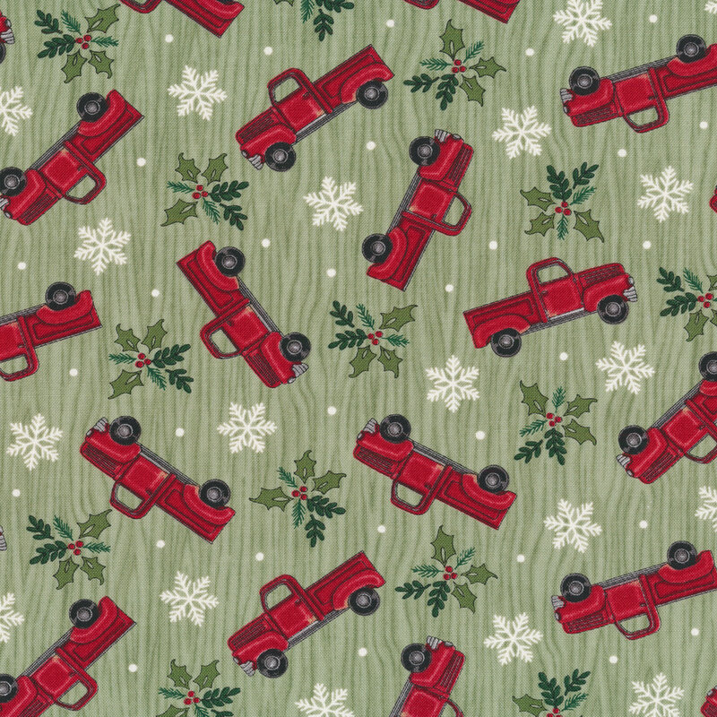 Tossed vintage trucks, snowflakes, and holly on a green wood grain background