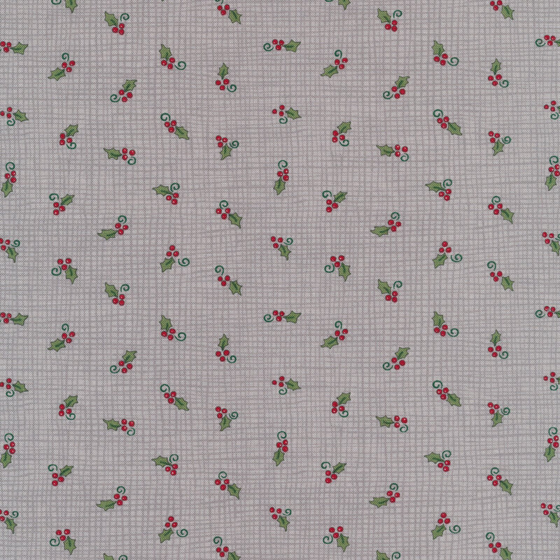 Tossed holly berries on a grey burlap texture background