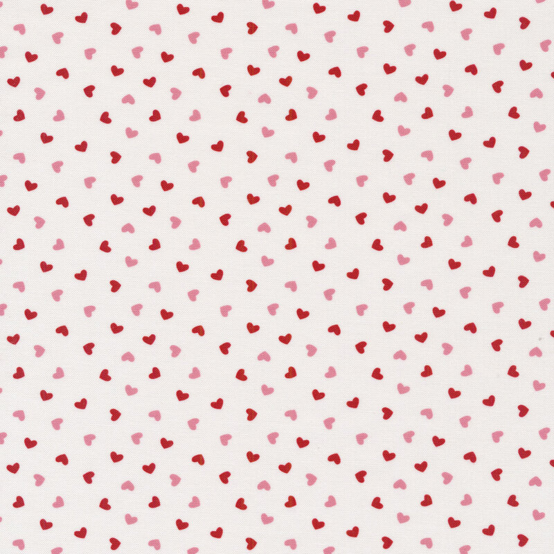 Tossed pink and red hearts all over a white background