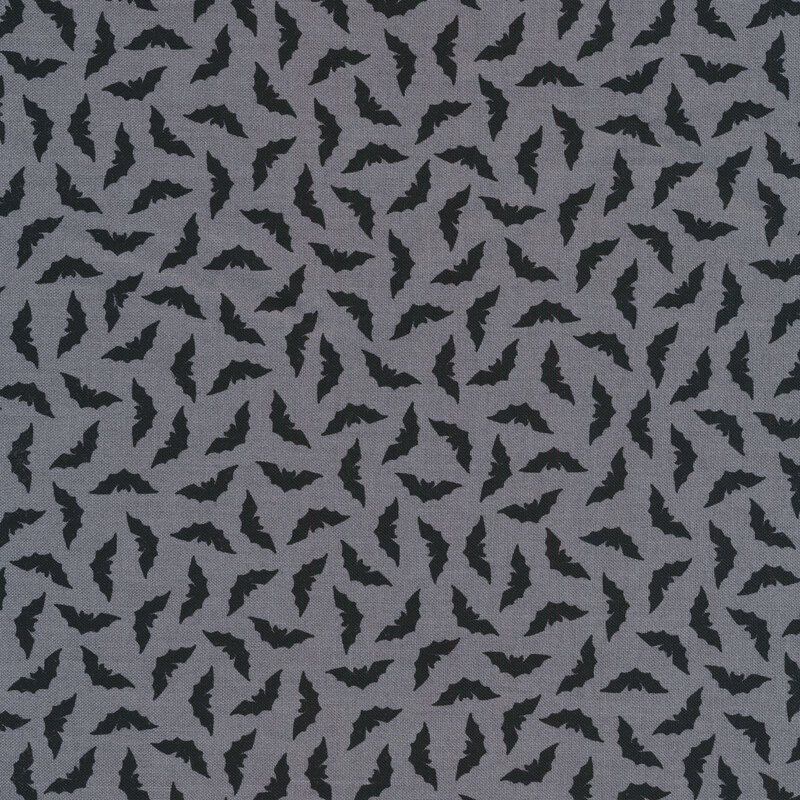 Tossed black bats on a gray background