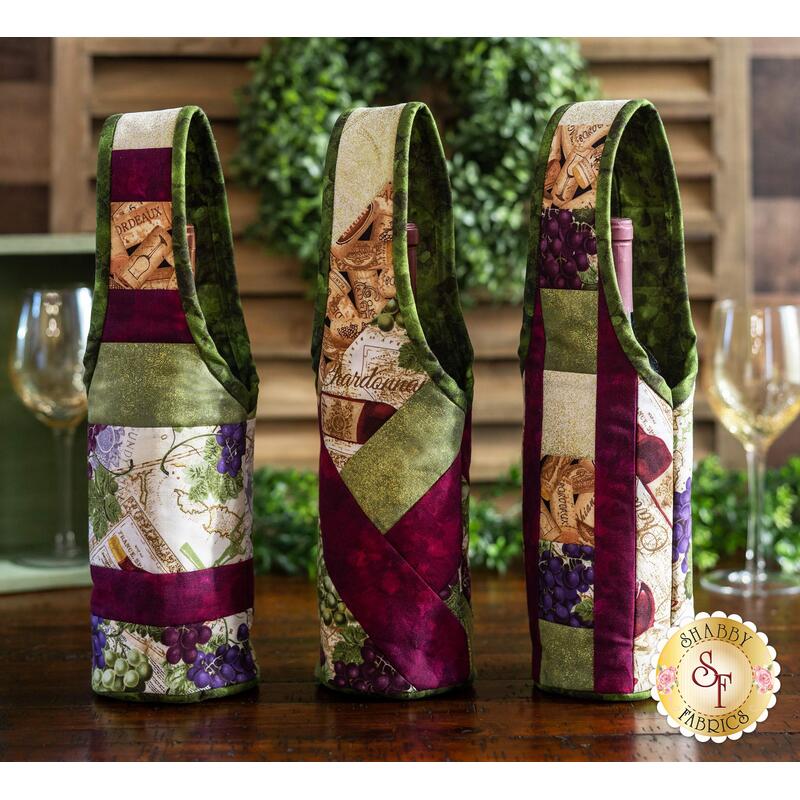 Three beautiful wine totes displayed on a dark wood table