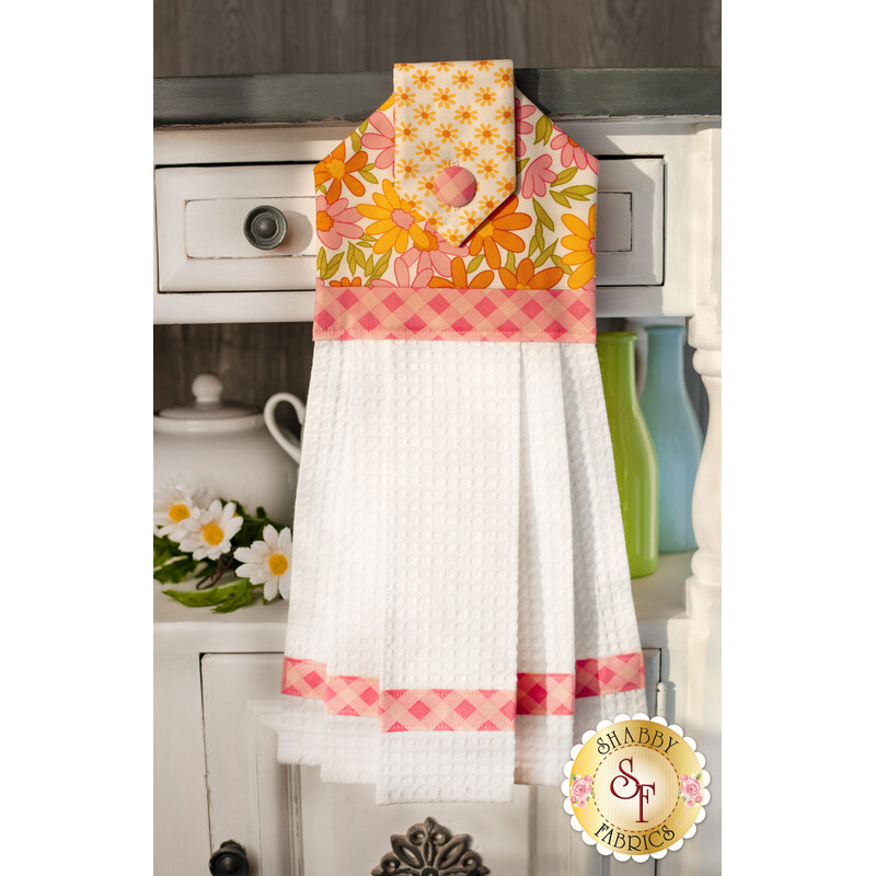 The beautiful Hanging Towel - A Blooming Bunch in Pink hung from a cabinet