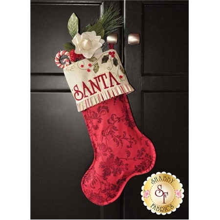Red stocking embroidered with SANTA in large letters and appliqued with holly berries and a cuff.