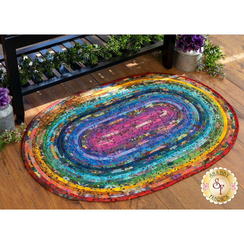 The Jelly Roll Rug - Venice displayed on a wood floor