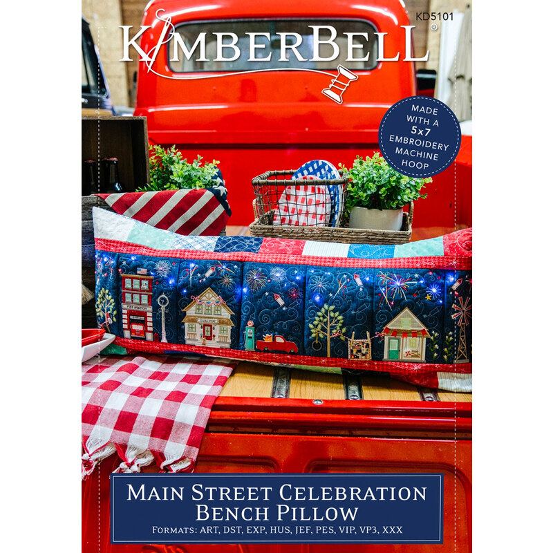 The front cover of the Main Street Celebration Bench Pillow Pattern Machine Embroidery Version, showing the finished pillow in the back of a vintage truck
