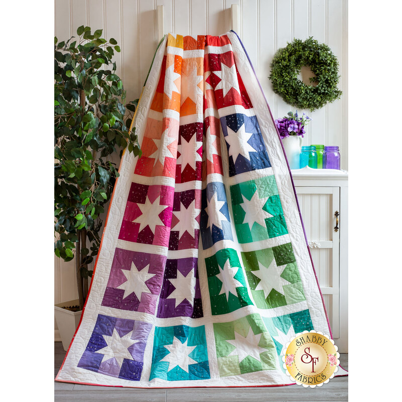 Joyful Stars Quilt draped over a ladder