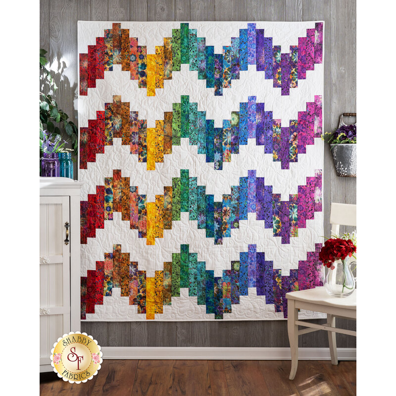 The stunning Ridiculously Easy Jelly Roll Quilt made with Venice fabrics hung on a wall