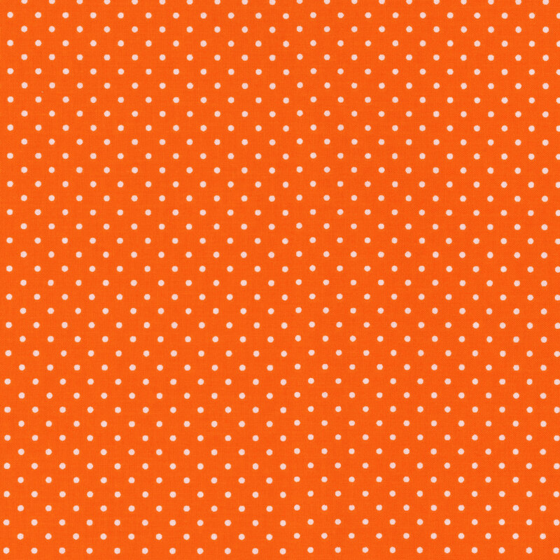 Orange fabric with little white polka dots