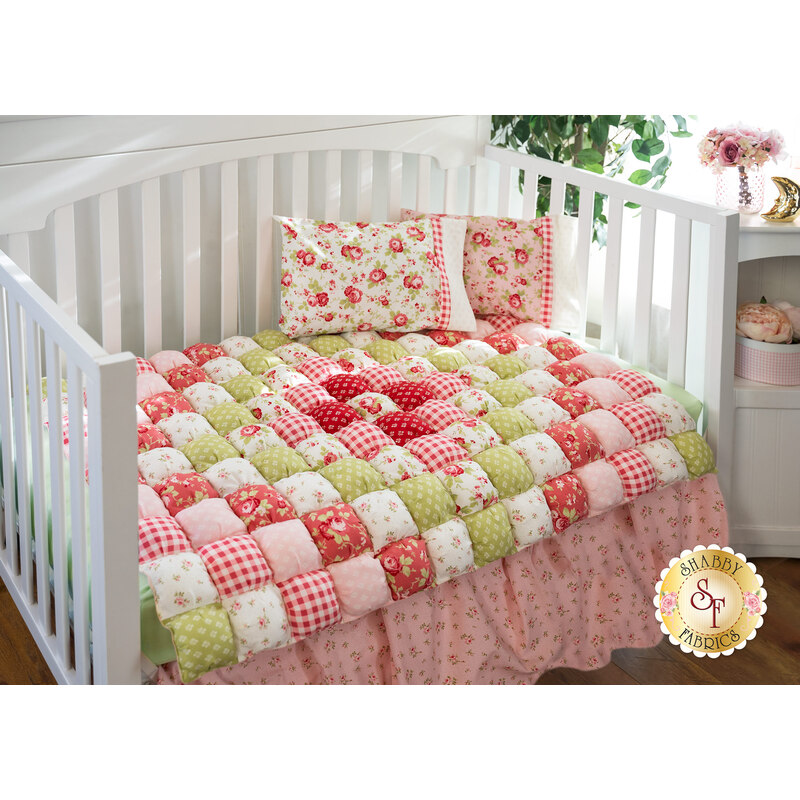 The adorable Sophie Bubble Quilt laid in a crib