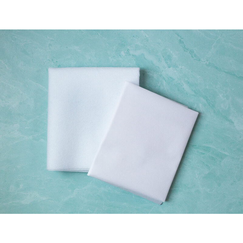 Fusible fleece and interfacing on a teal marbled countertop