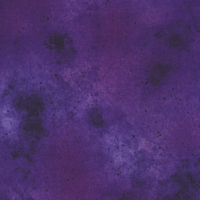 Dark purple mottled fabric with black speckles all over