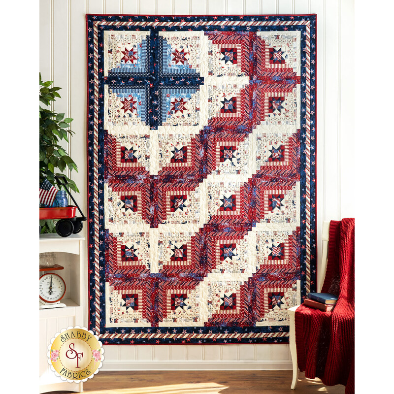 The beautiful patriotic Log Cabin Americana Quilt - Liberty Lane hung on a wall