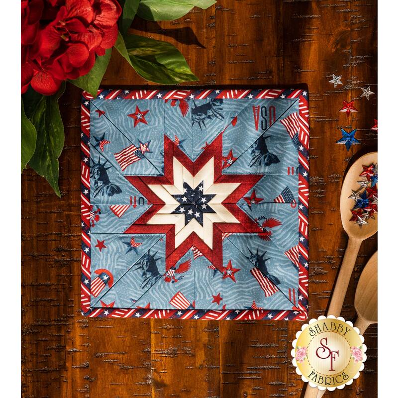 Red, white, and blue square hot pad laid flat on a brown wood table