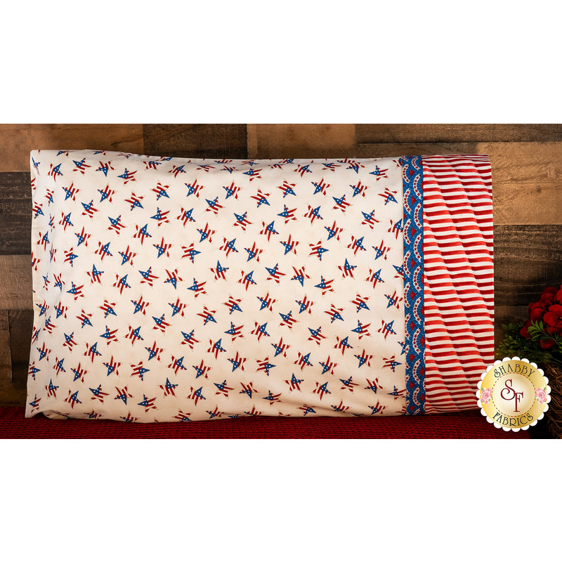 Patriotic pillowcase covered in red, white, and blue stars resting on a bed