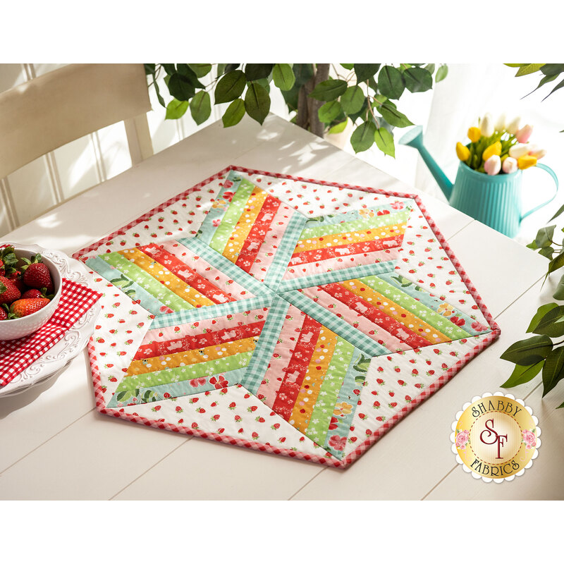 Patriotic red, white, and blue 60 degree table topper on a wood table