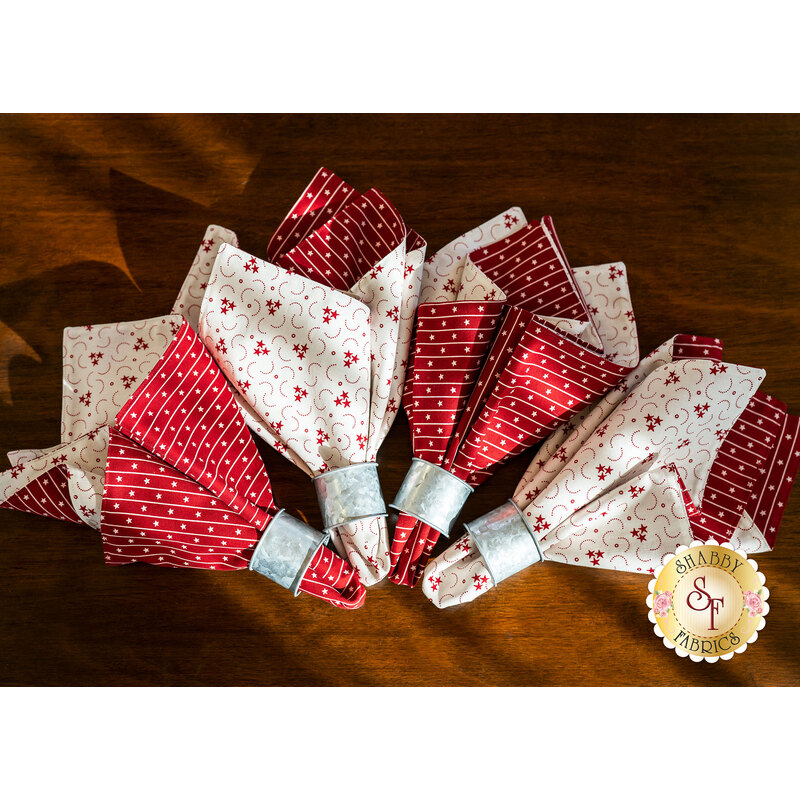 4 beautiful cloth napkins made with American Gathering fabrics on a brown table