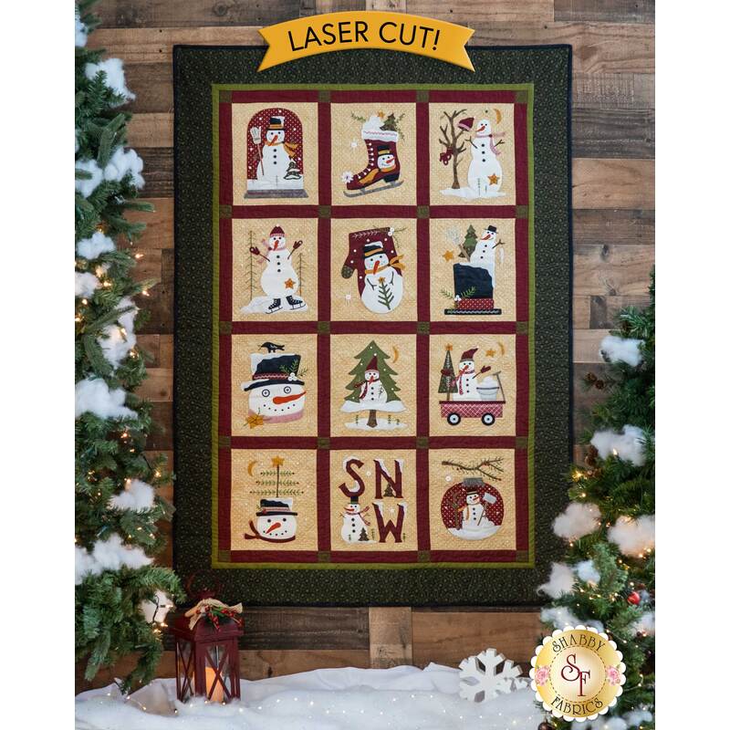 The beautiful Winter Wonderland Laser Cut Quilt displayed on a wall | Shabby Fabrics