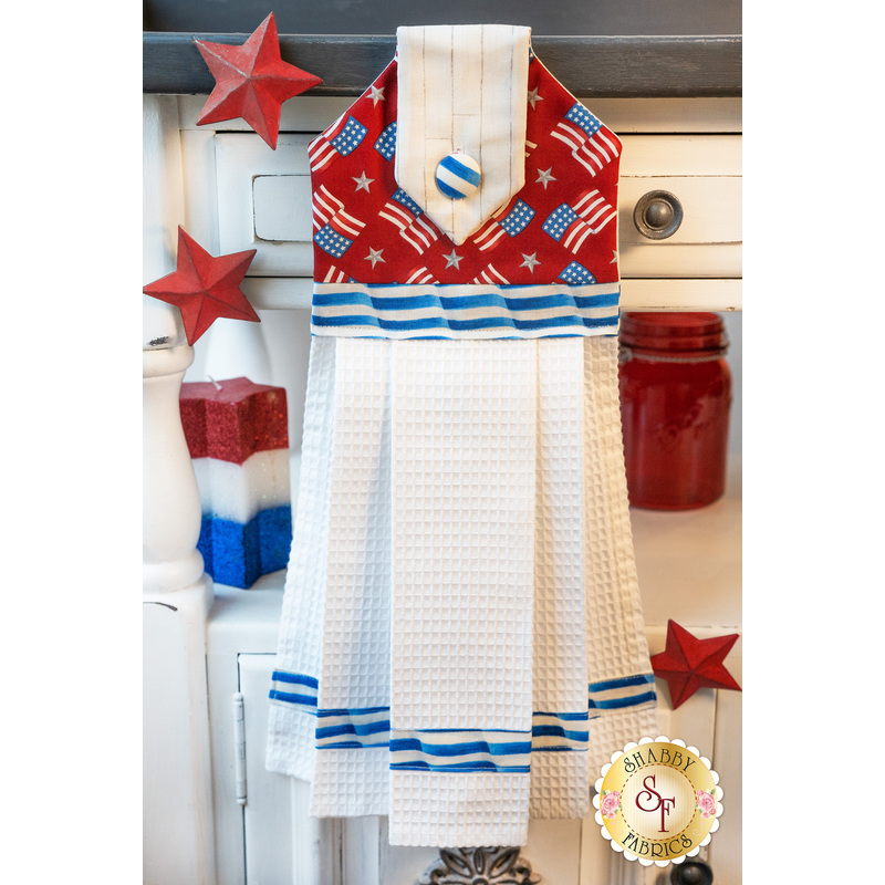 Patriotic red, white, and blue hanging towel hung from a cabinet