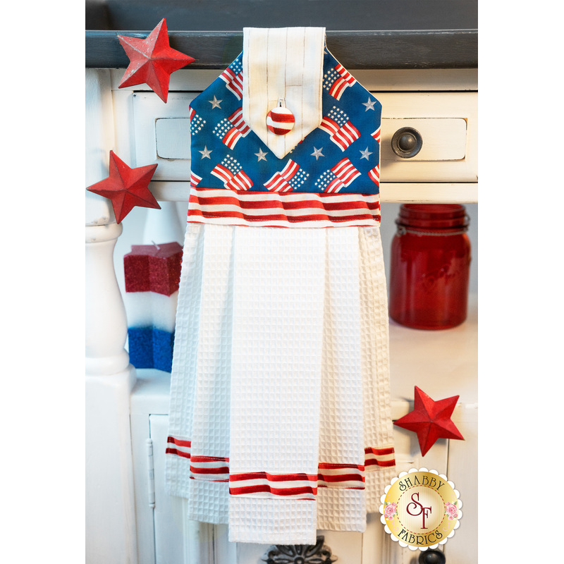 Patriotic red, white, and blue hanging towel hung from a cabinet