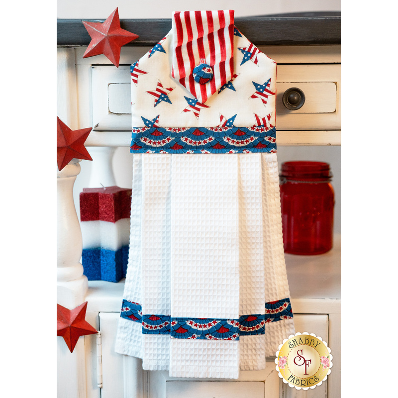 Patriotic red, white, and blue hanging towel hung from a cabinet