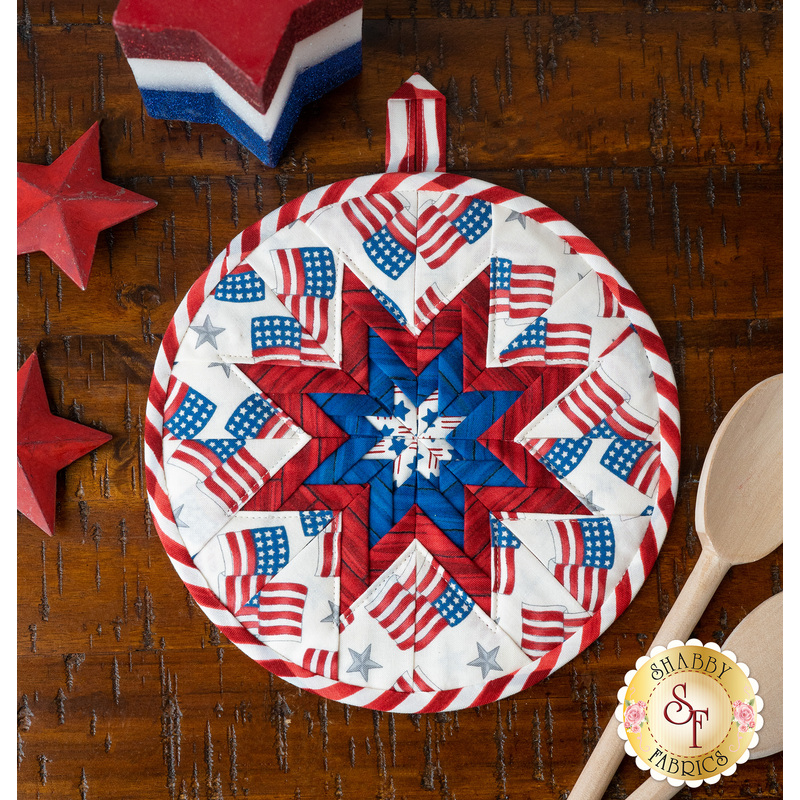 Patriotic hot pad made with America the Beautiful fabrics on a wood table
