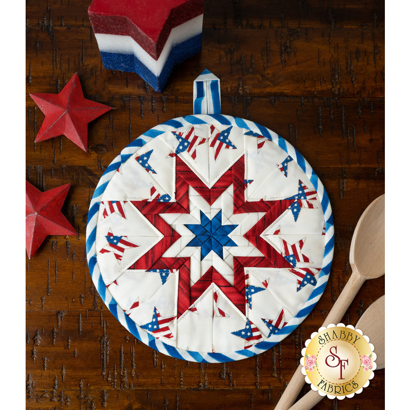 Patriotic hot pad made with America the Beautiful fabrics on a wood table