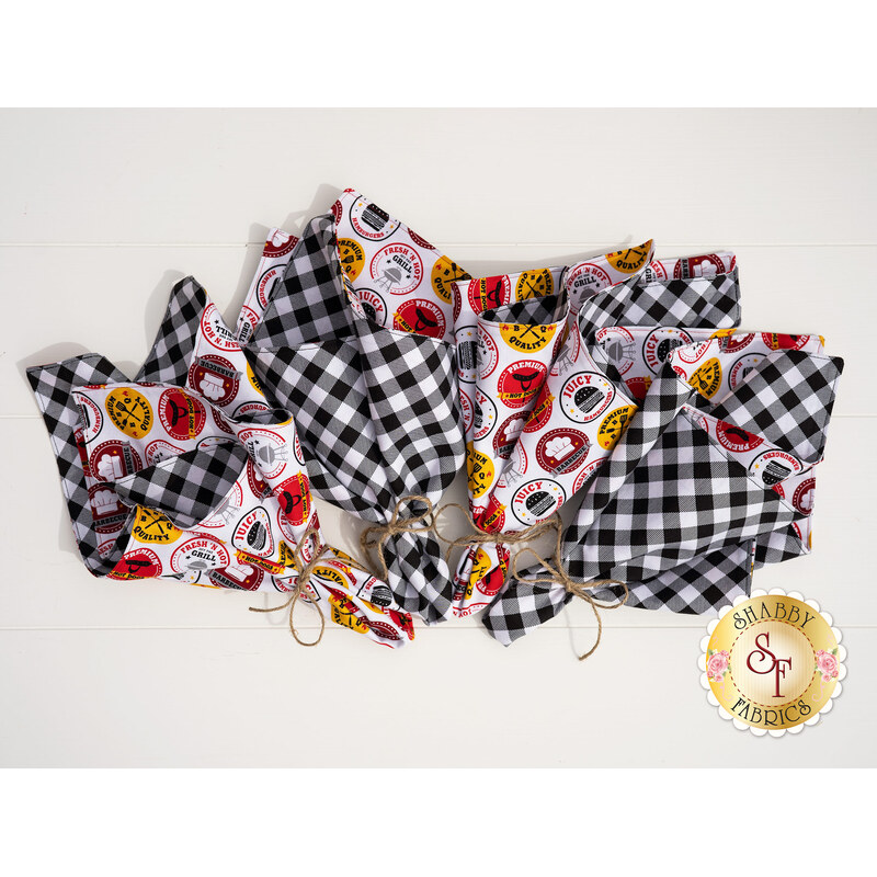 4 Peace, Love & BBQ cloth napkins on a white background