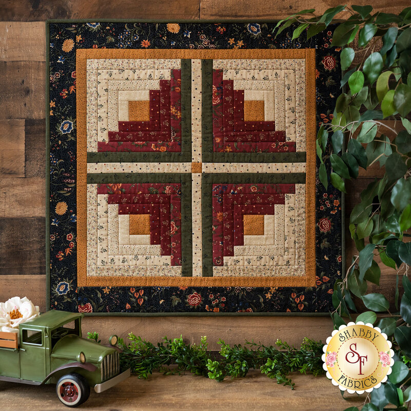 The beautiful Prairie Dreams Log Cabin Wall Hanging displayed on a wall