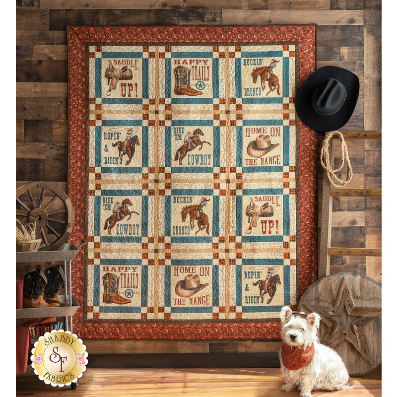 The beautiful Home On The Range Panel Quilt hung from a rustic wall