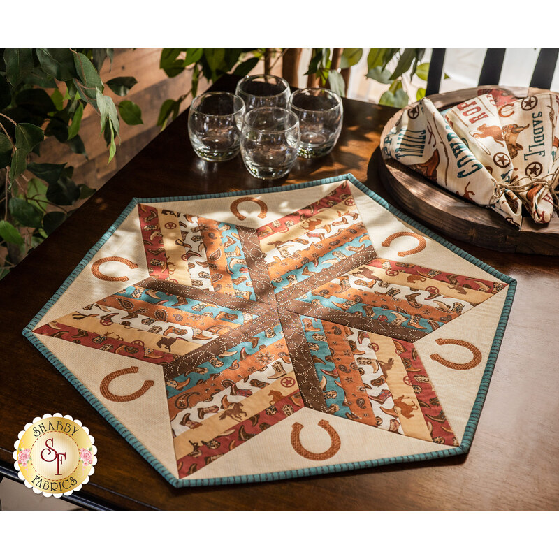 The adorable Home On The Range 60 Degree Diamond Table Topper displayed on a wood table