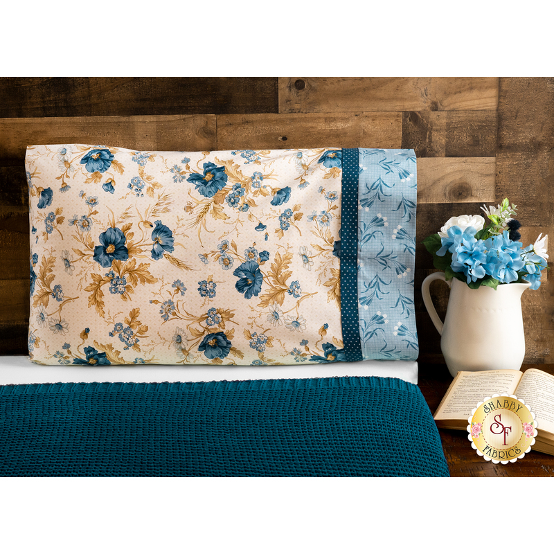 Beautiful red, cream and pink floral pillowcase on a bed | Shabby Fabrics