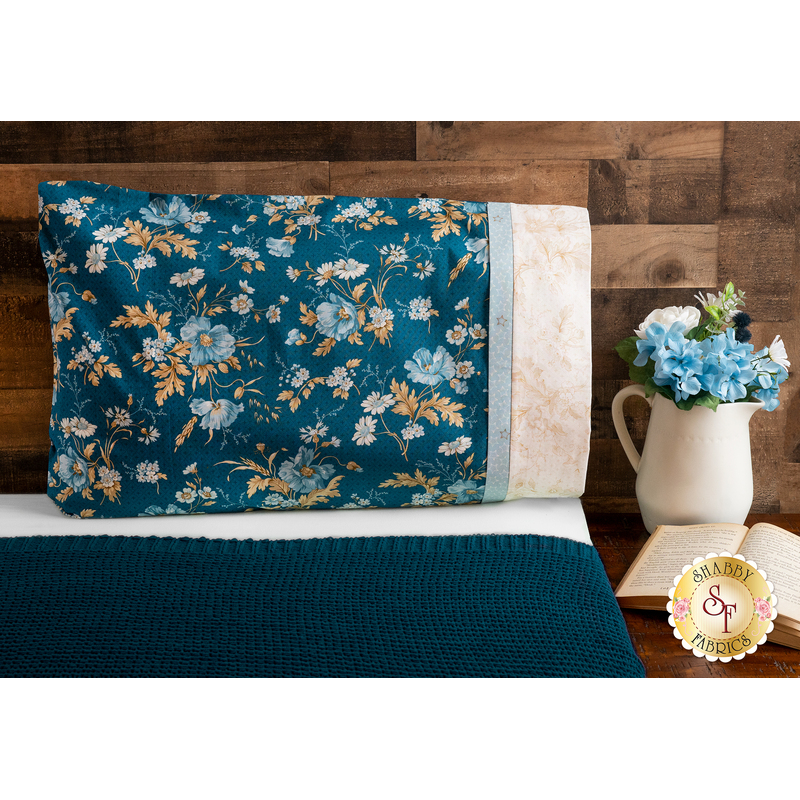 Beautiful red, cream and pink floral pillowcase on a bed | Shabby Fabrics