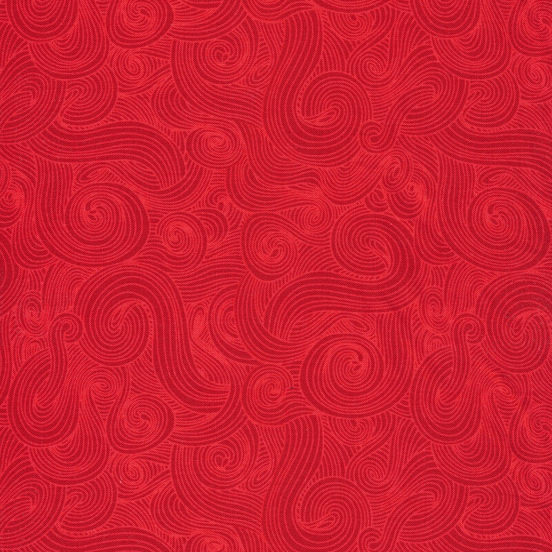 Tonal red fabric with dark swirls on a lighter background 
