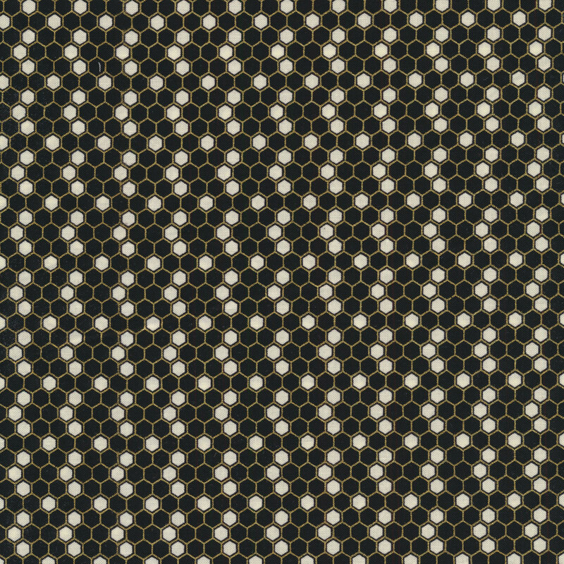 A sewing fabric with a black and white hexagon pattern all over with metallic accents