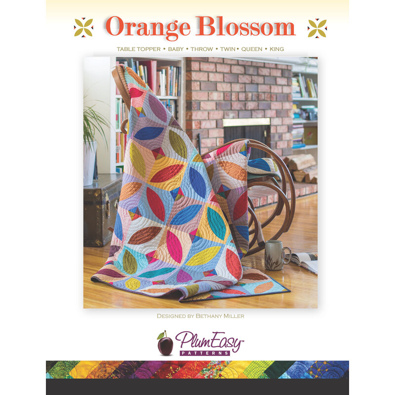 front cover of Orange Blossom Quilt pattern with a sample quilt draped over a rocking chair