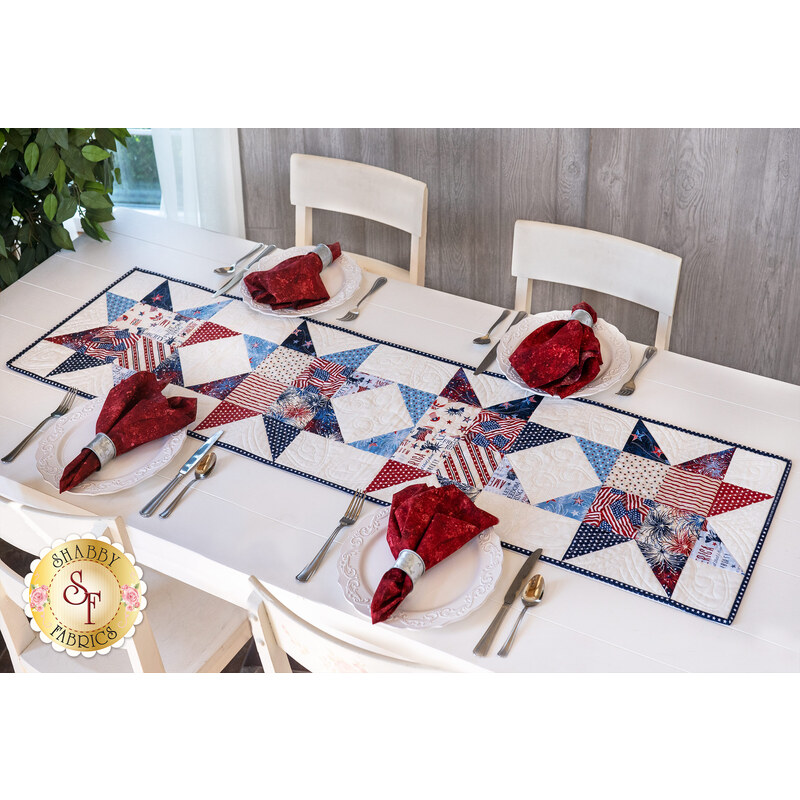 A beautifully set dining table with the Zig Zag Stars Table Runner made with Liberty Lane fabrics