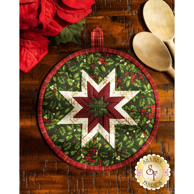 Navy blue floral circular hot pad on a wood table