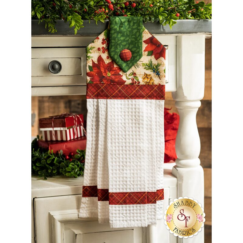 The patriotic red, white, and blue patriotic hanging towel hung from a cabinet