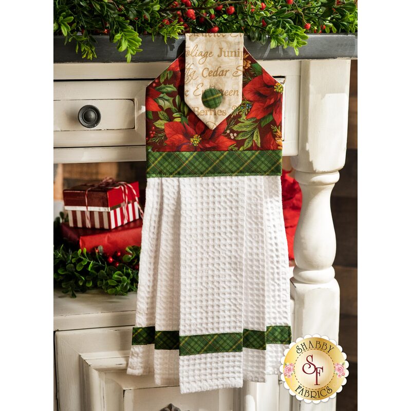 The patriotic red, white, and blue patriotic hanging towel hung from a cabinet