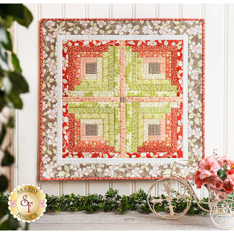 The beautiful Courthouse Steps Wall Hanging made with Strawberries & Rhubarb hung on a wall
