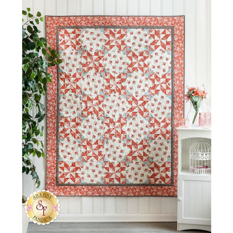 The beautiful Sanctuary Patchwork Quilt draped from a wall